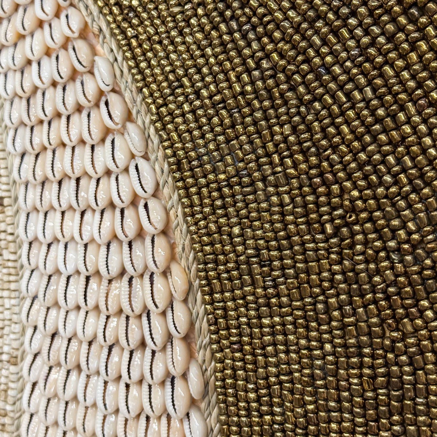 Close-up of a textured surface with shell pattern on the left and woven fabric pattern on the right.
