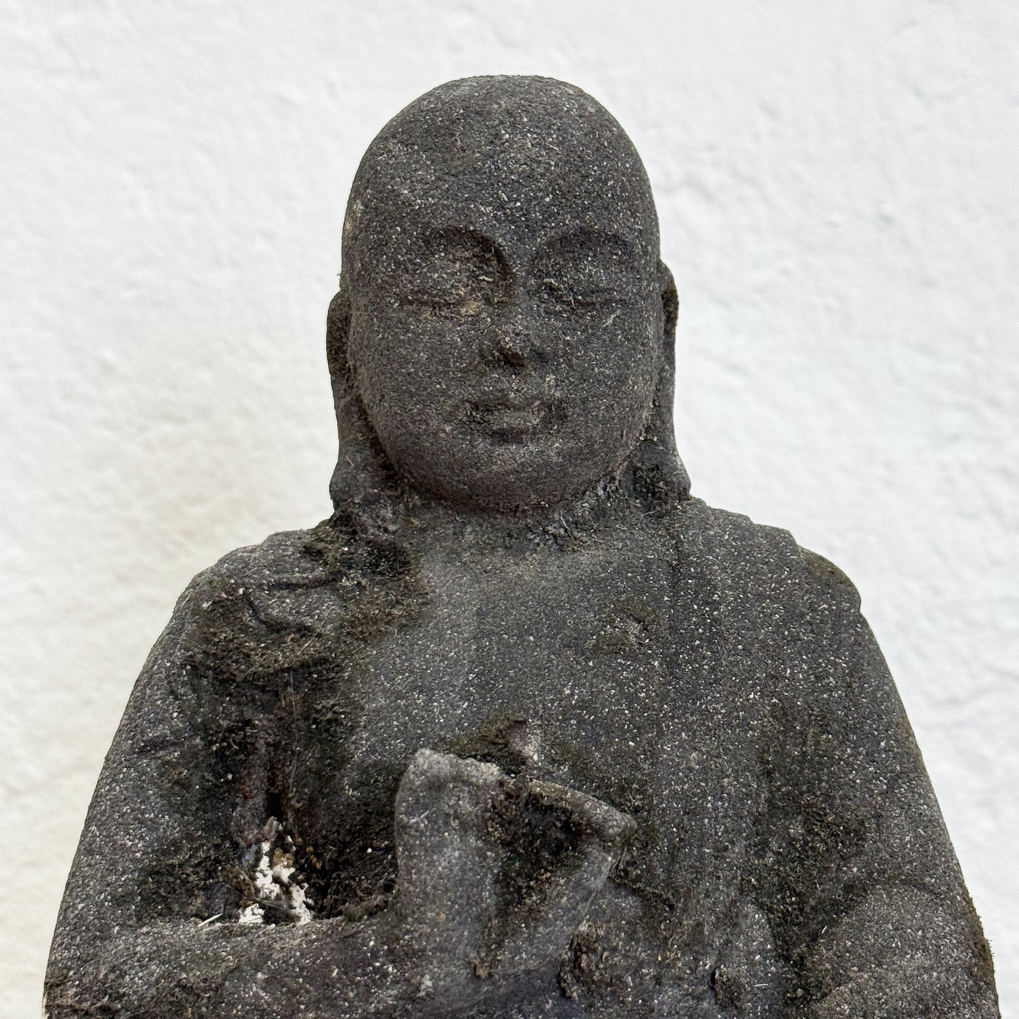 Stone statue of a seated figure 