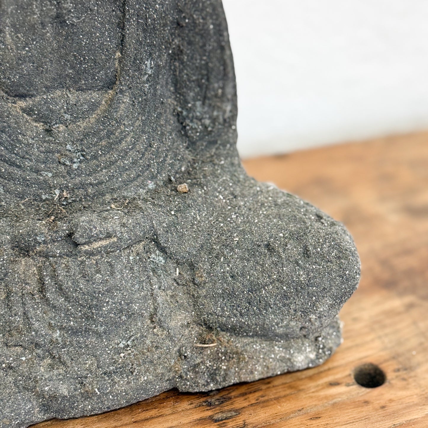 Close-up of a stone sculpture on a wooden surface