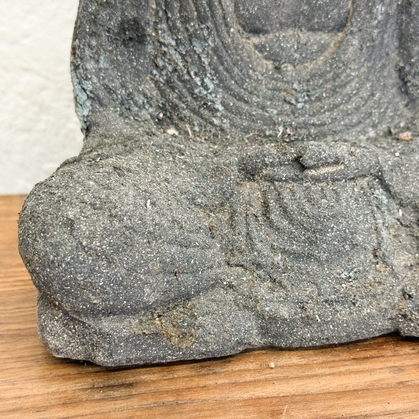 Close-up of a stone sculpture on a wooden surface
