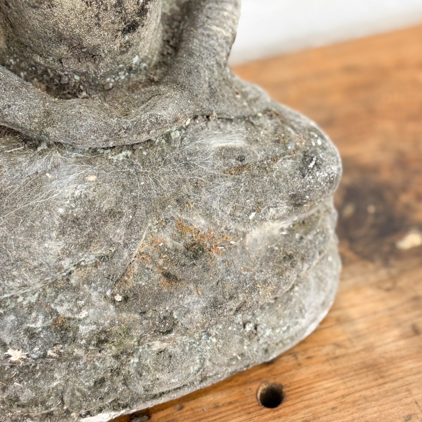 Close-up of a stone lantern on a wooden surface