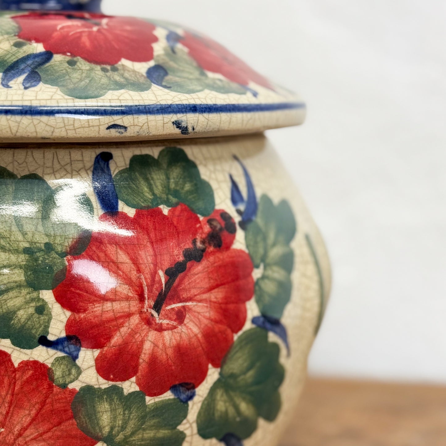 Ceramic jar with floral design on a white background