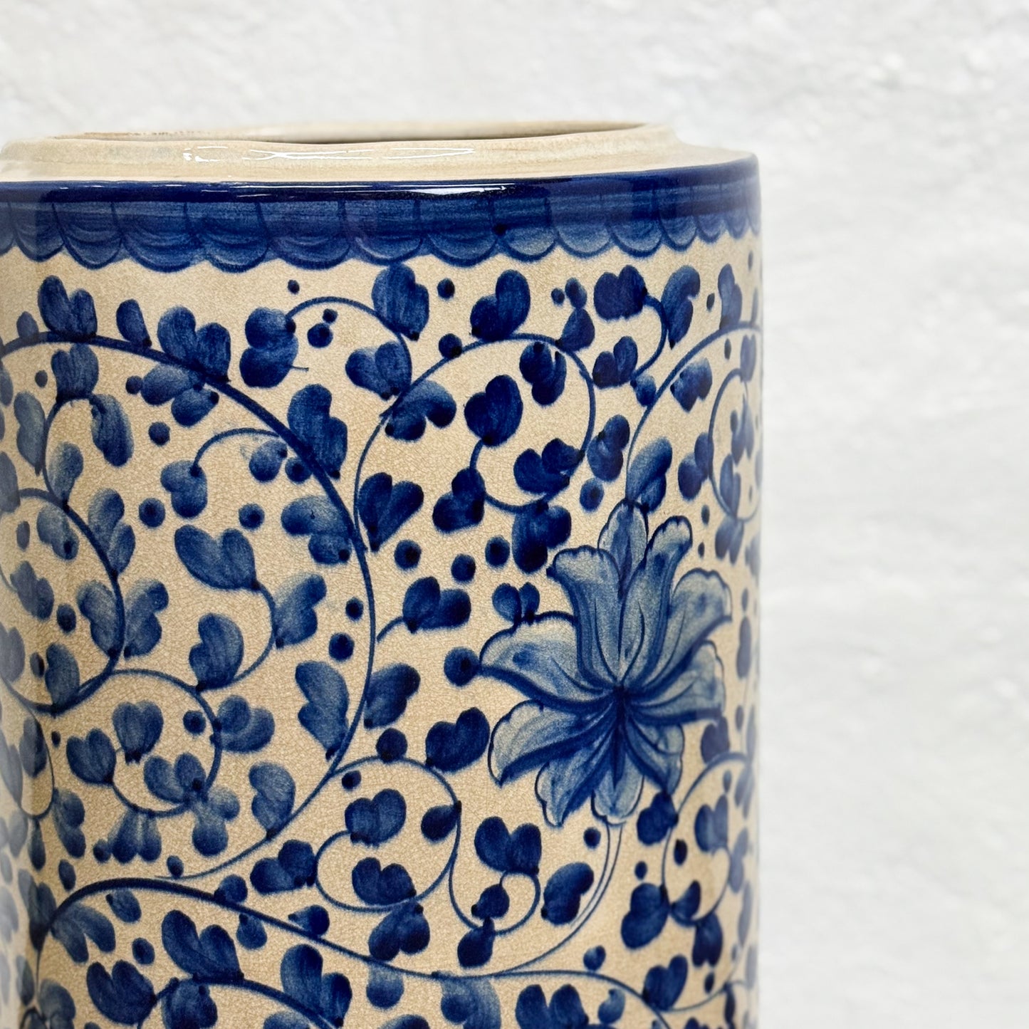 Ceramic vase with blue floral pattern on a white background