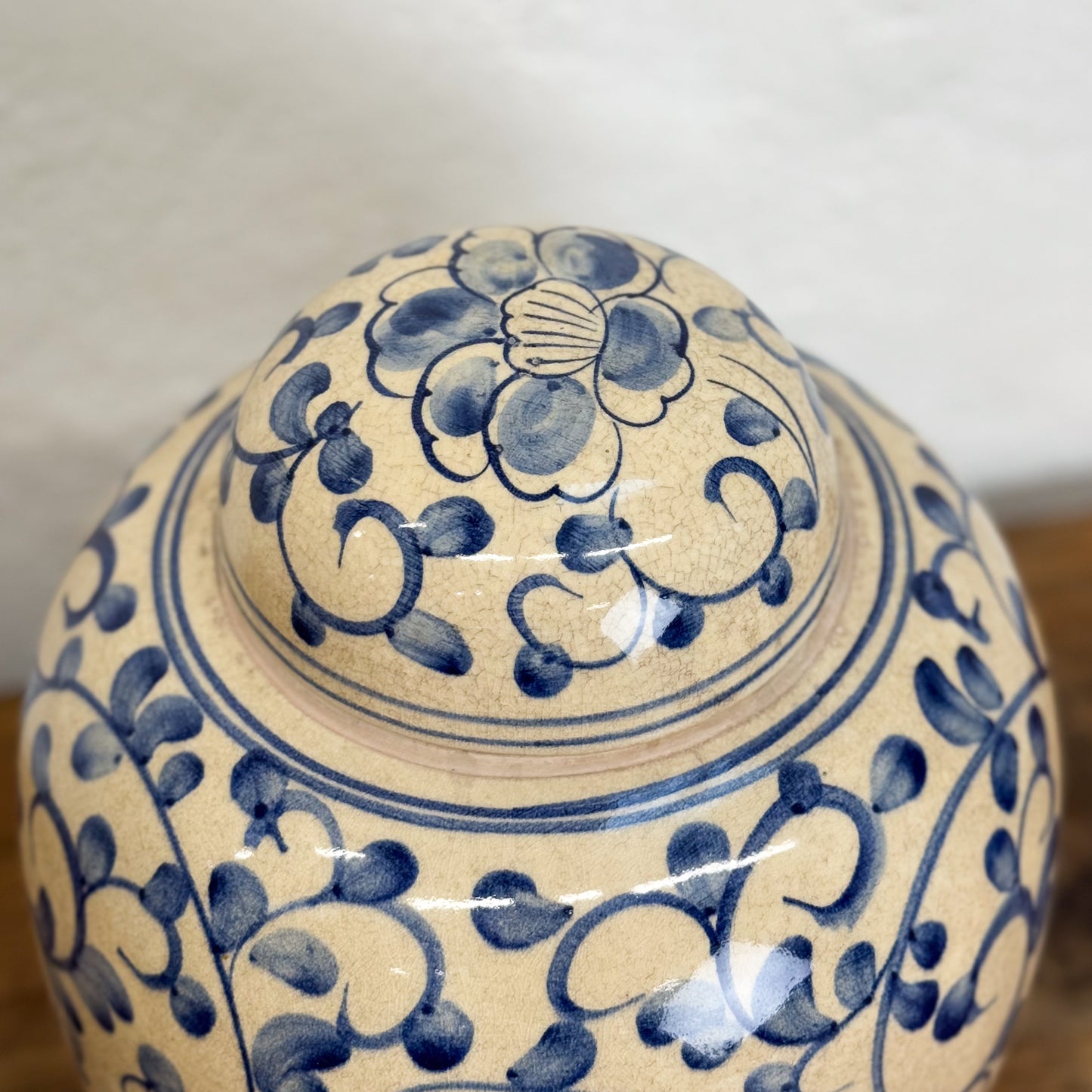 Ceramic jar with blue floral patterns on a plain background