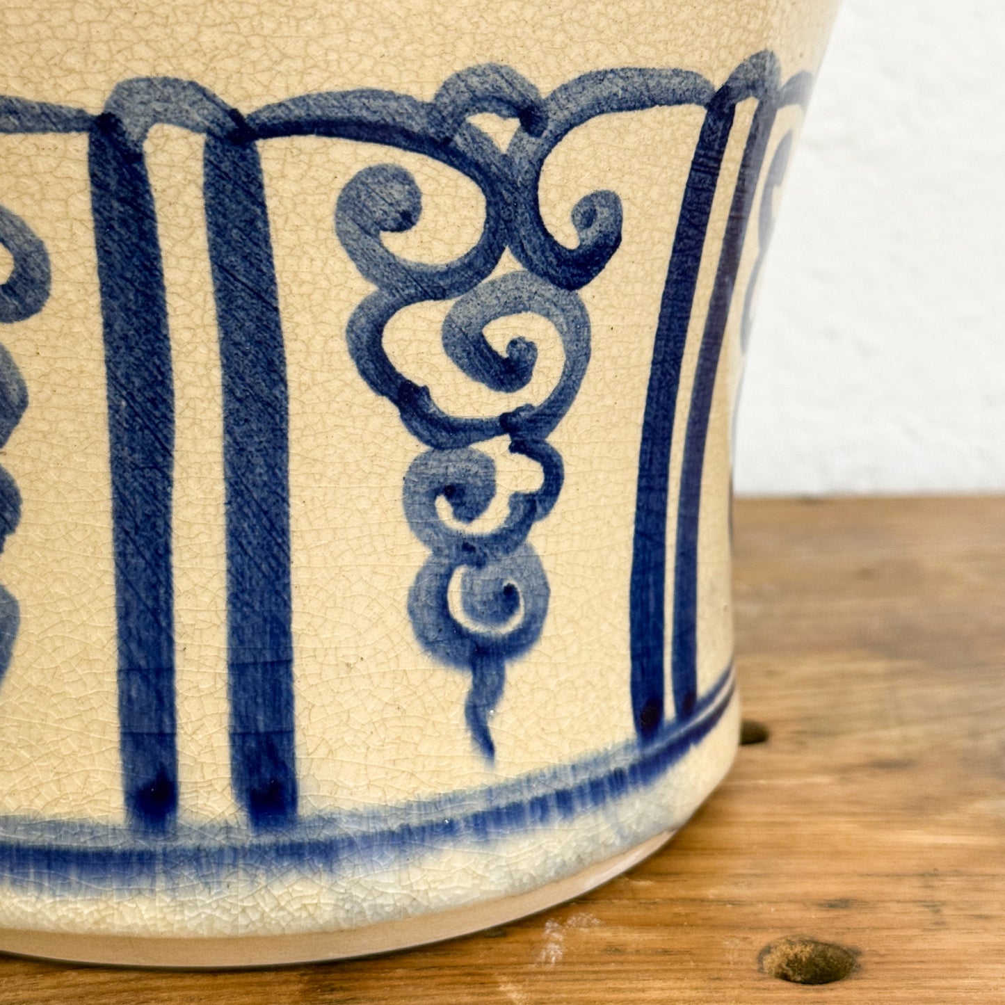Ceramic mug with blue decorative patterns on a wooden surface