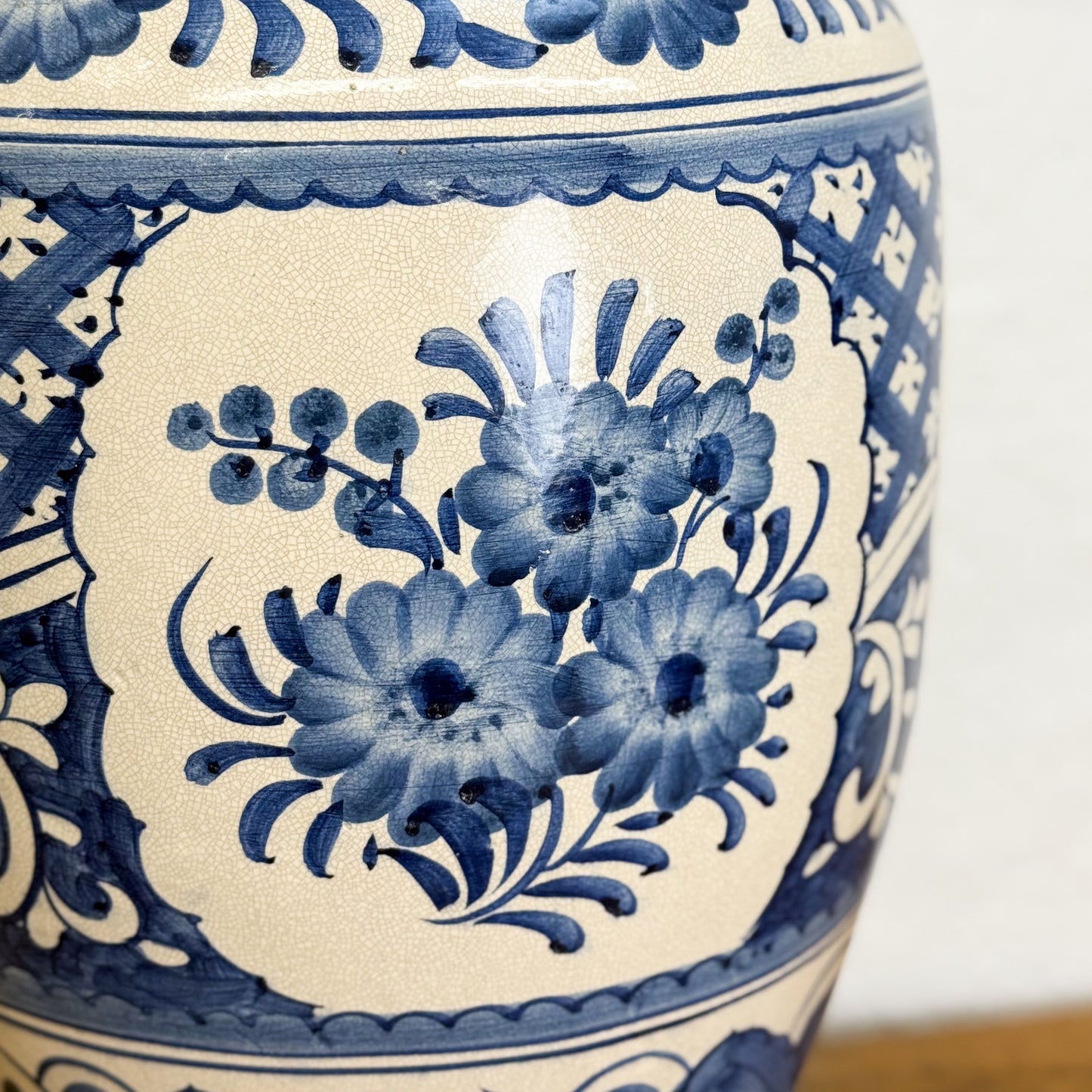 Close-up of a blue and white ceramic vase with floral patterns