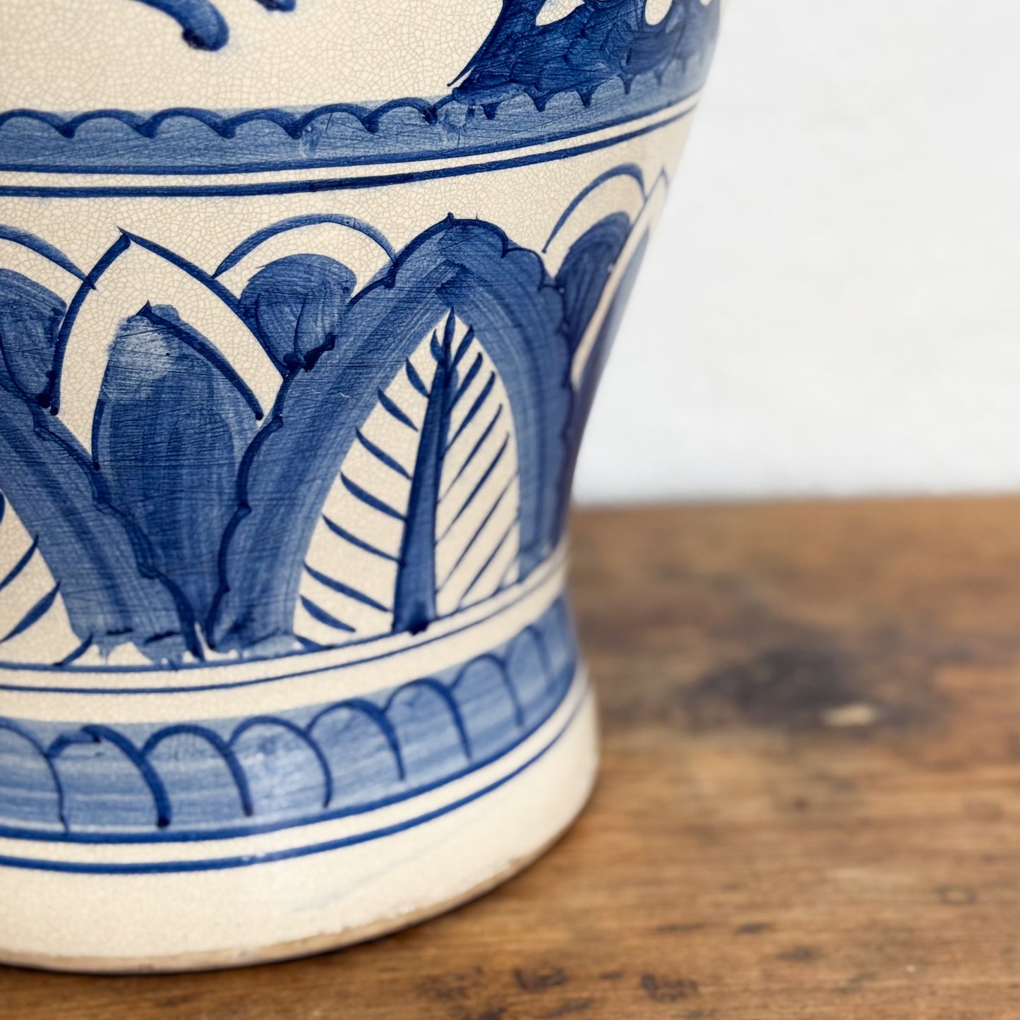 Blue and white ceramic vase with intricate patterns on a wooden surface