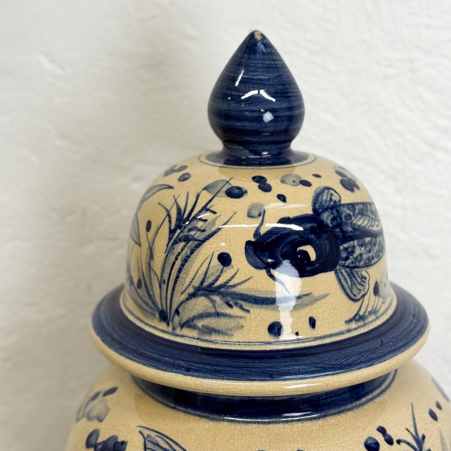 Ceramic jar with blue floral patterns on a white background