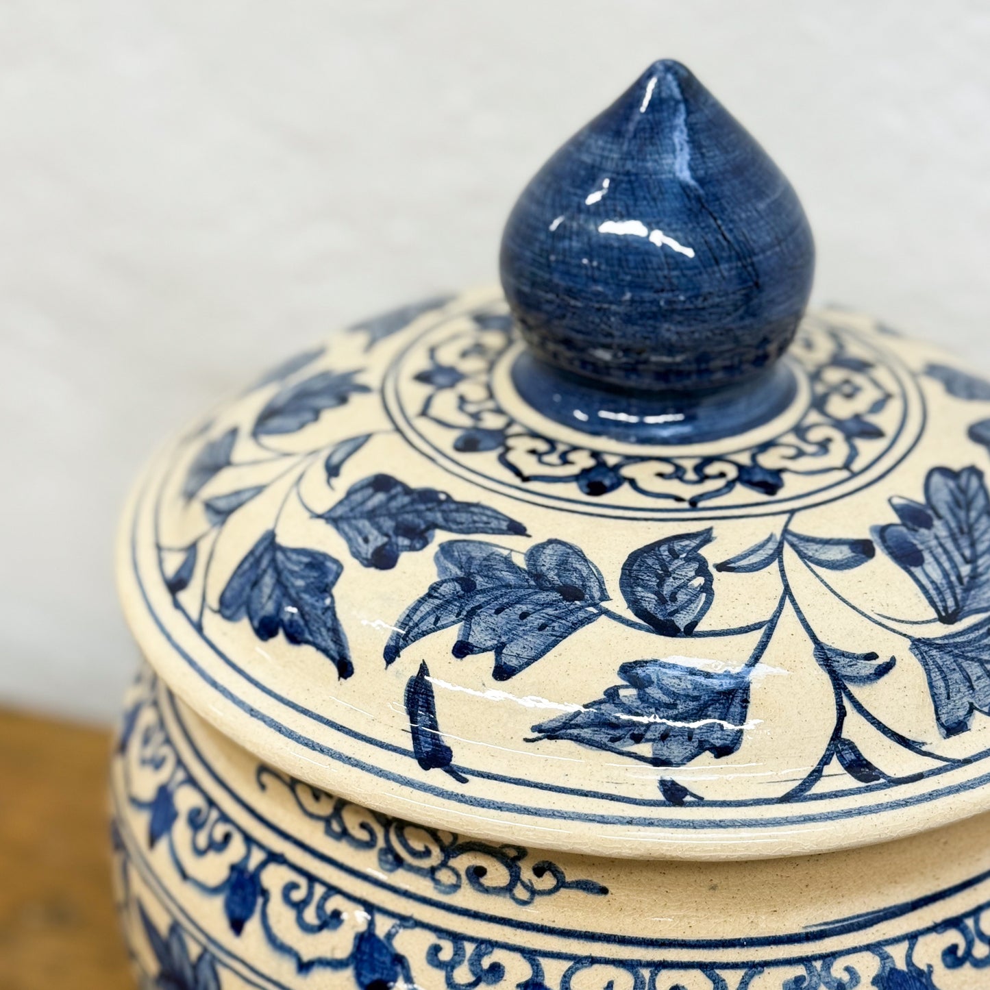 Ceramic jar with blue floral patterns on a white background