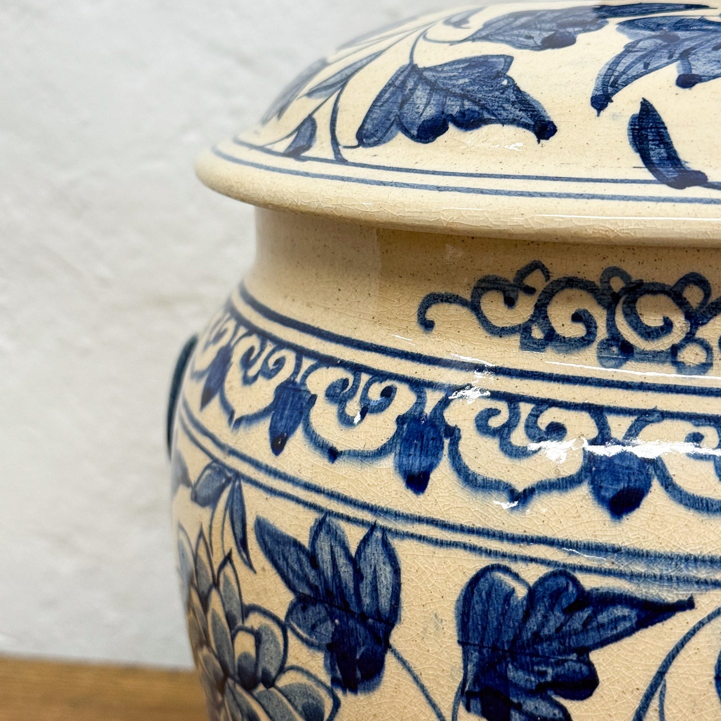 Ceramic jar with blue floral patterns on a white background
