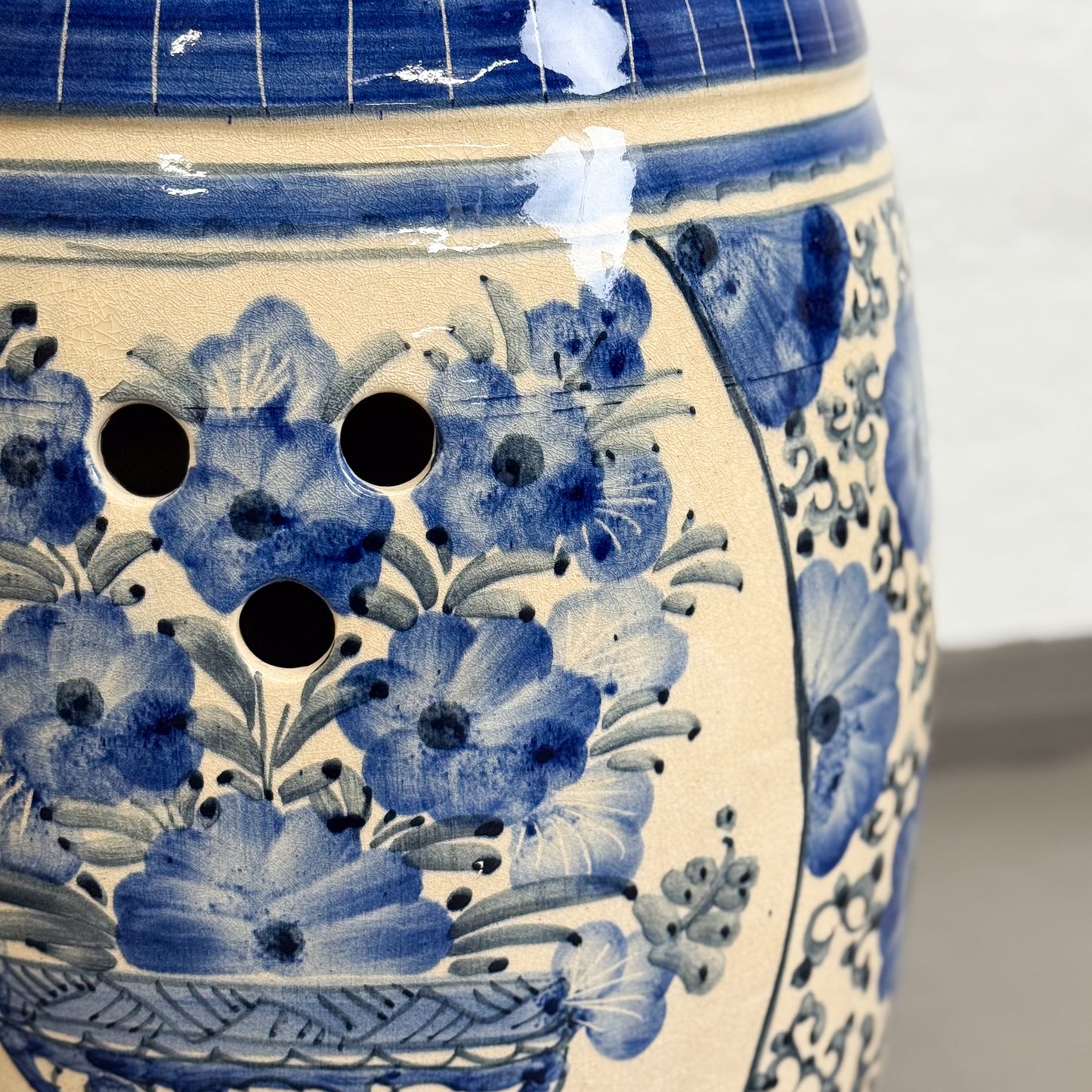 Close-up of a ceramic vase with blue floral patterns on a white background