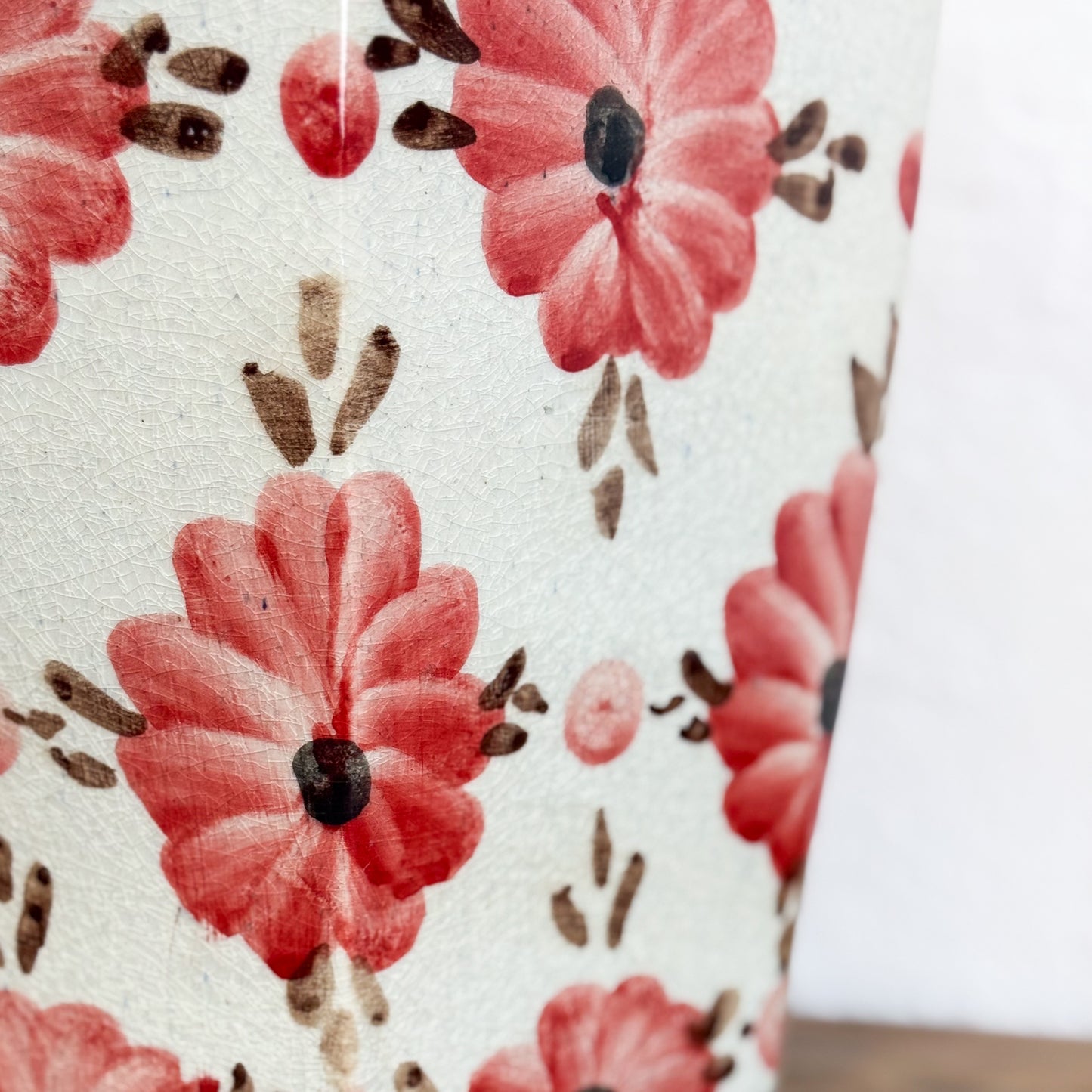 Floral pattern with red flowers and brown leaves on a white background