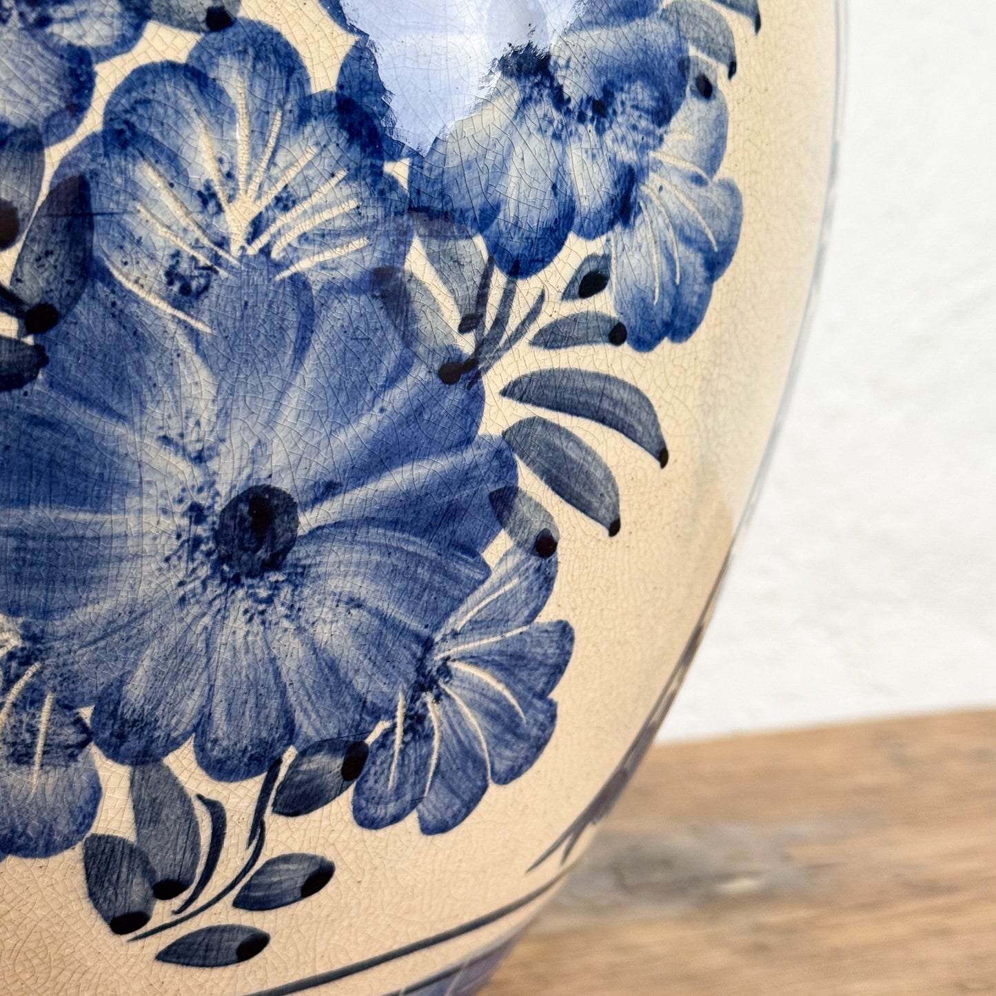 Close-up of a ceramic plate with blue floral design on a wooden surface