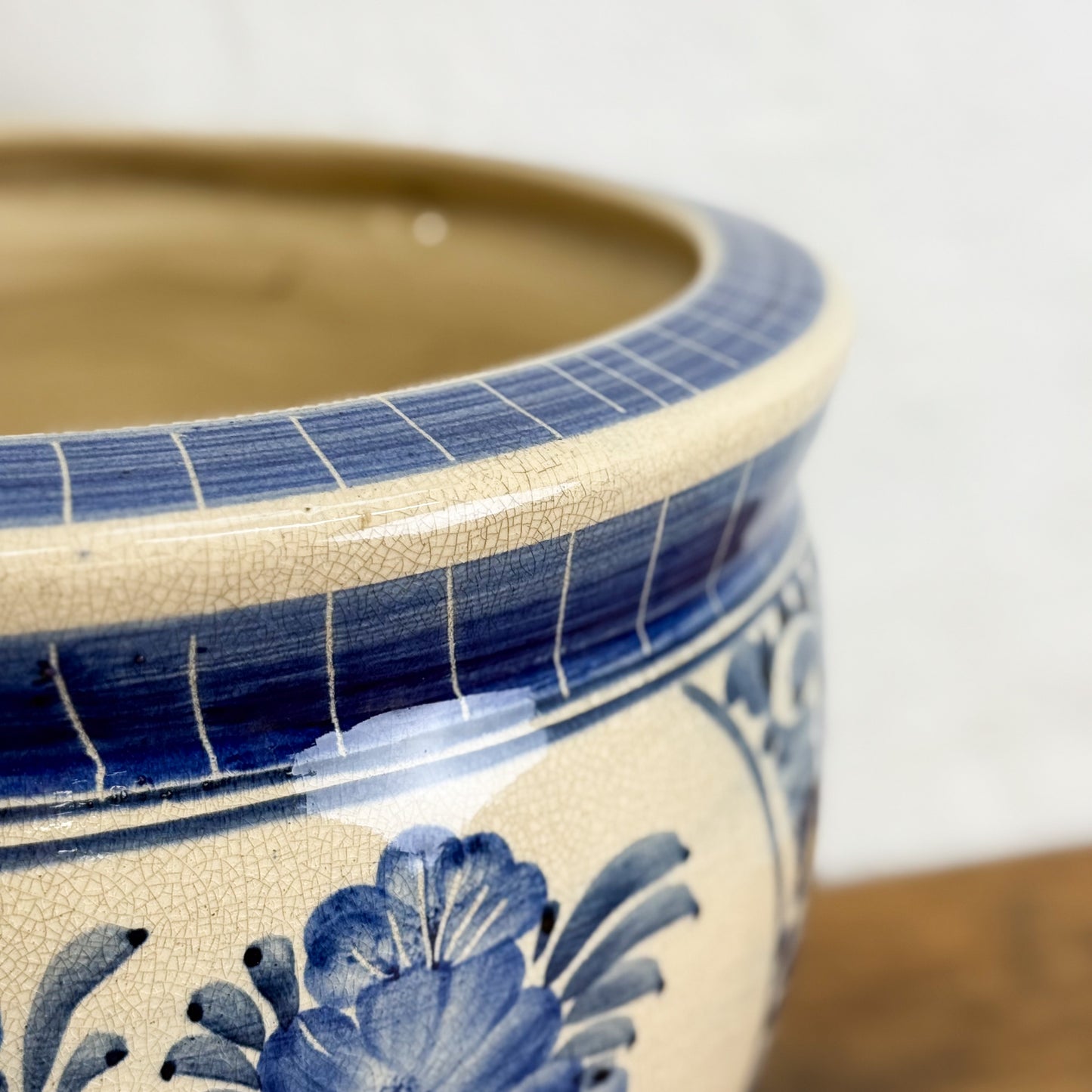 Ceramic pot with blue floral design on a white background