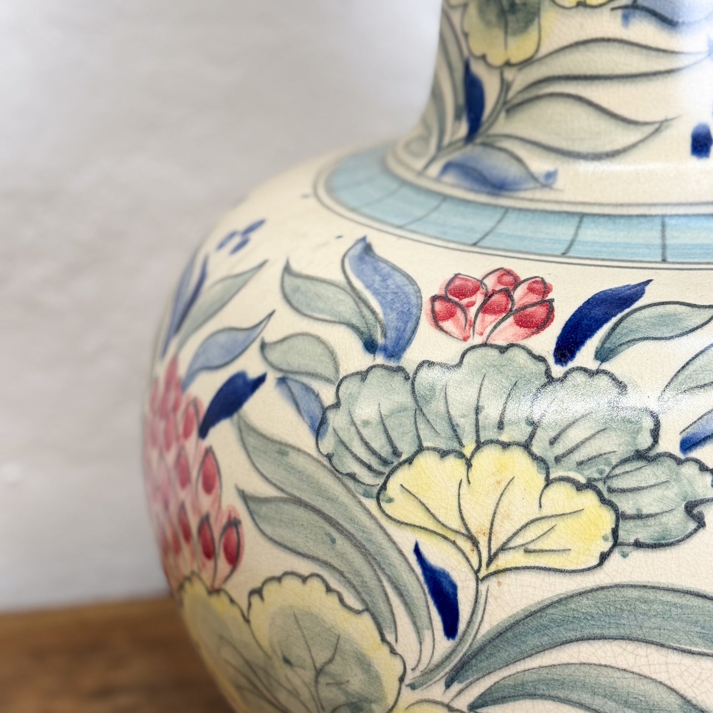 Close-up of a ceramic vase with floral patterns on a white background