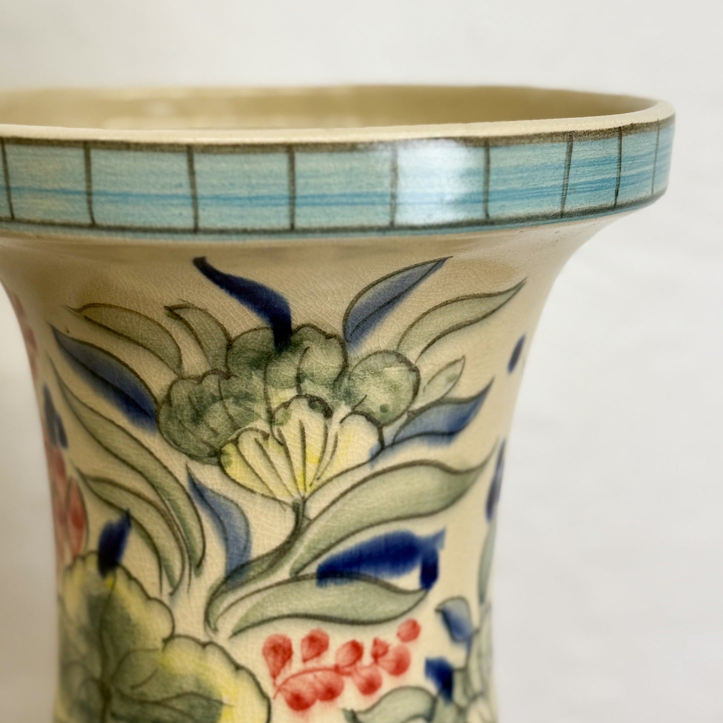 Ceramic vase with floral design on a white background