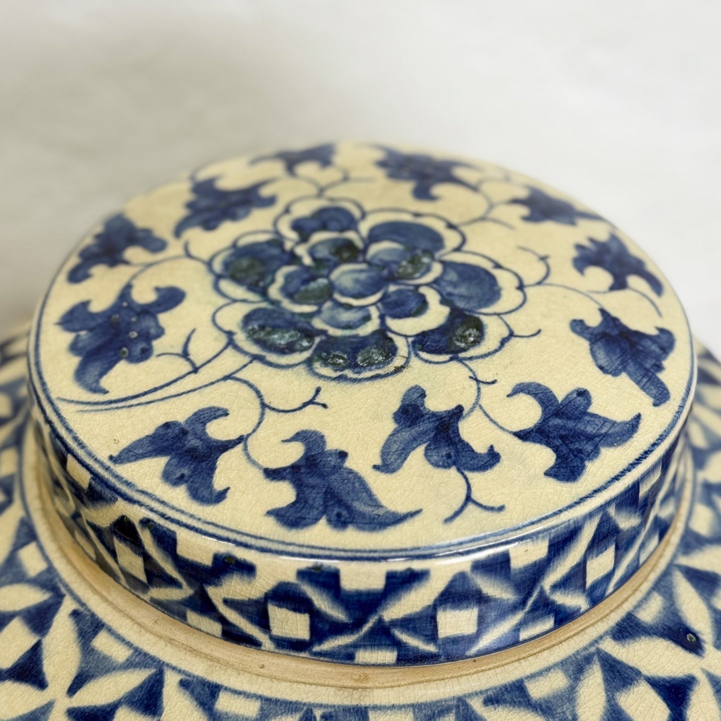 Blue and white ceramic container with intricate floral patterns on a white background