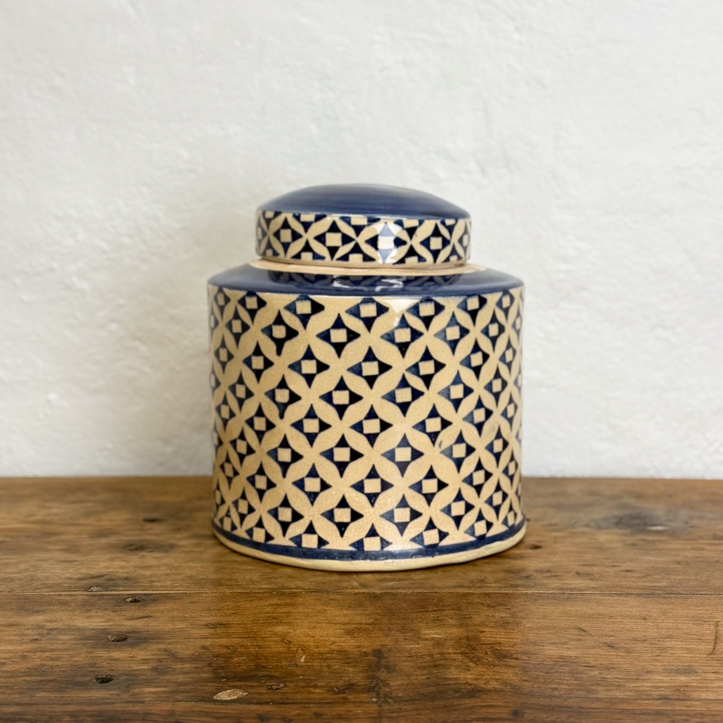 Ceramic jar with geometric pattern on a wooden surface