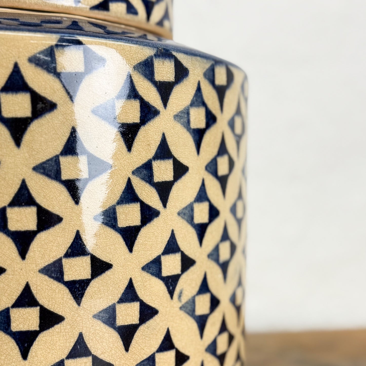 Ceramic jar with geometric pattern on a white background