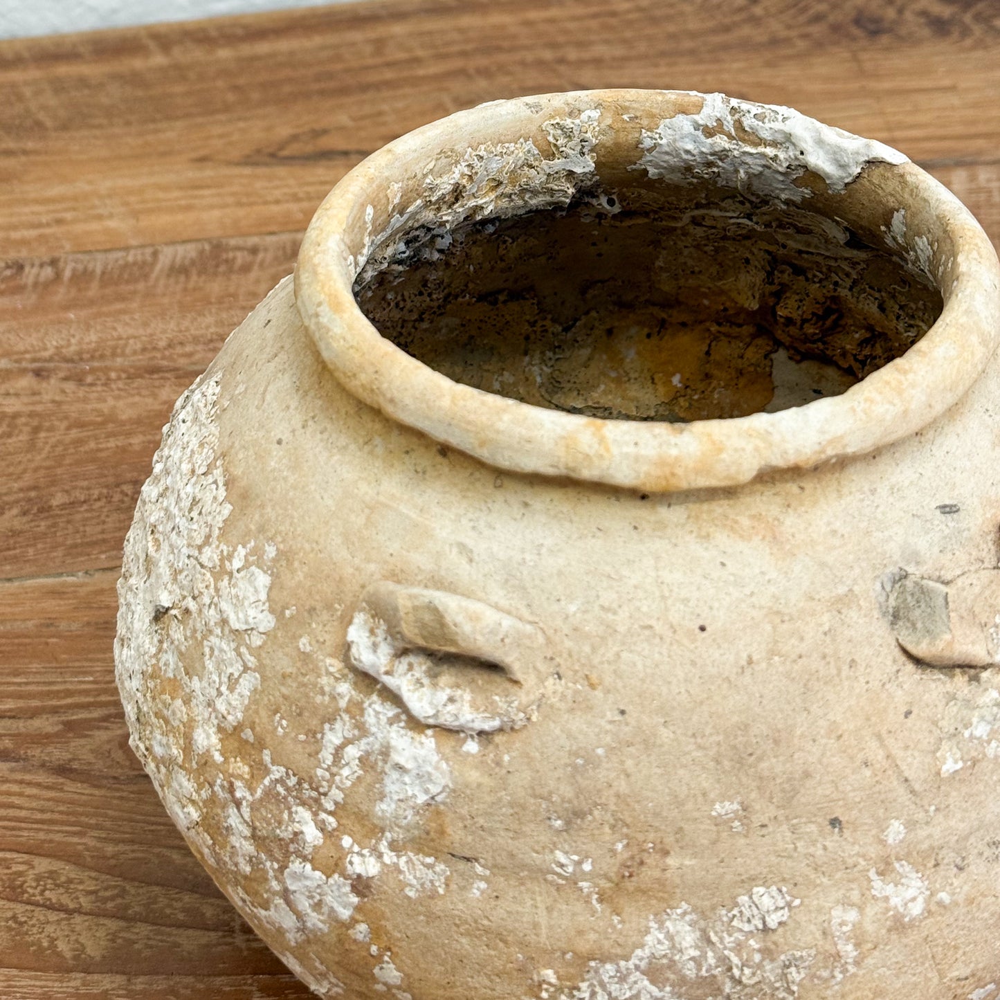 Old ceramic pot on a wooden surface