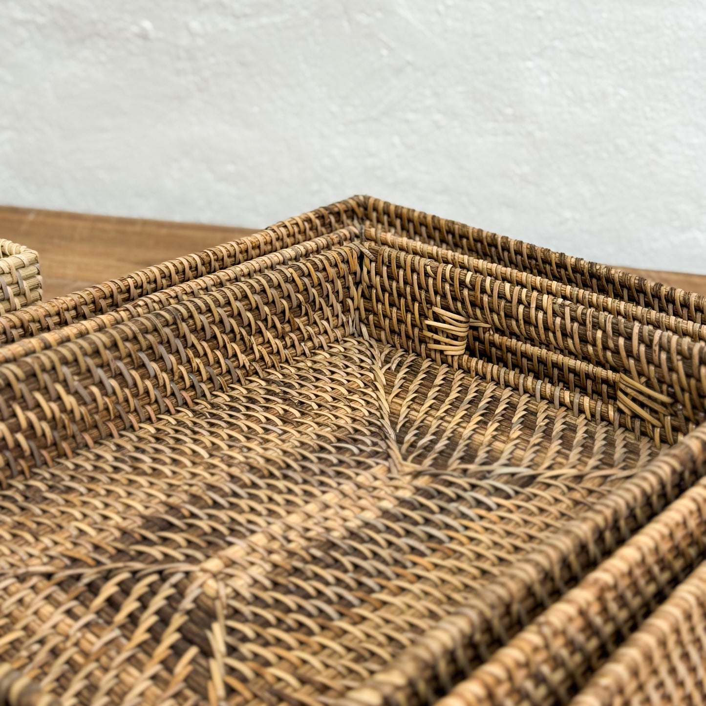 Close-up of a woven rattan tray with a textured background