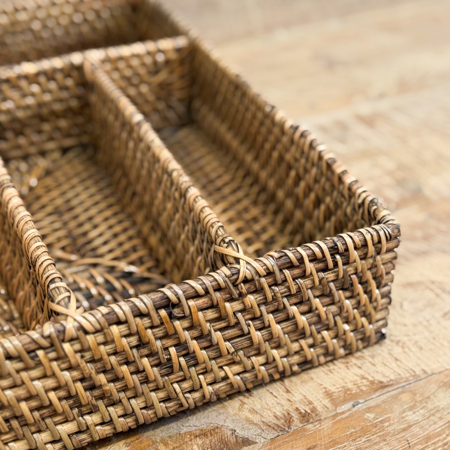 Woven rattan basket on a wooden surface