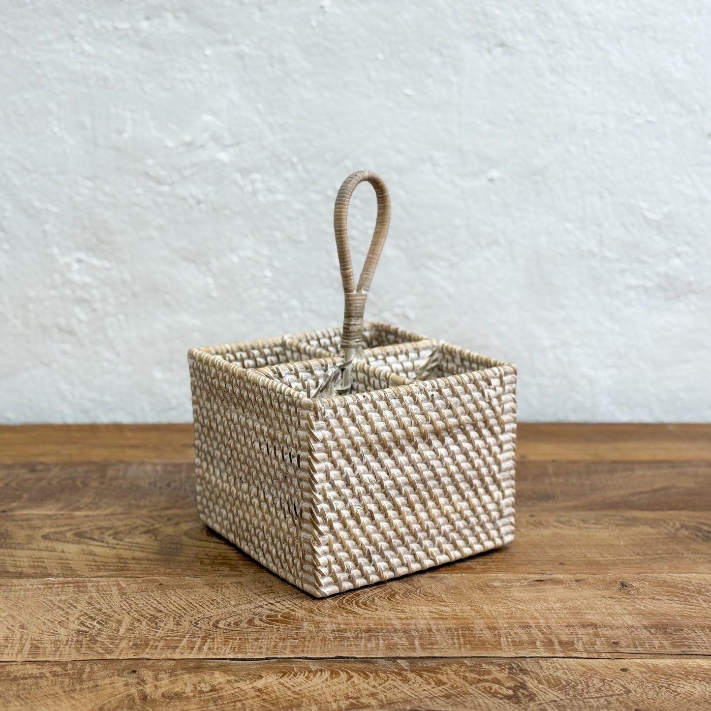 Woven basket with a handle on a wooden surface