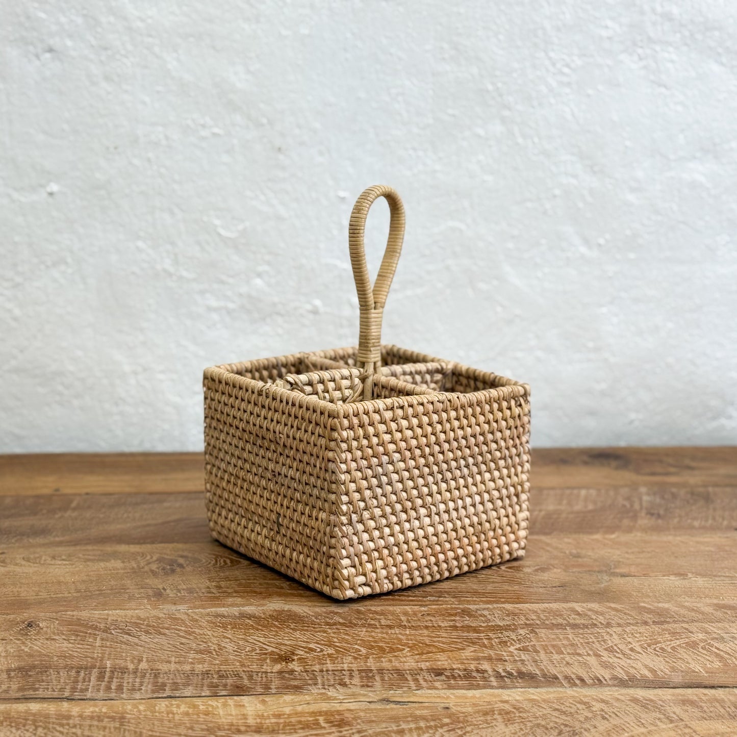 Woven basket with a handle on a wooden surface
