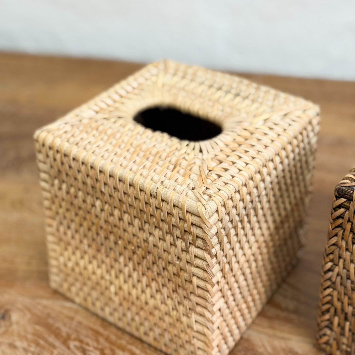 Woven tissue box cover on a wooden surface