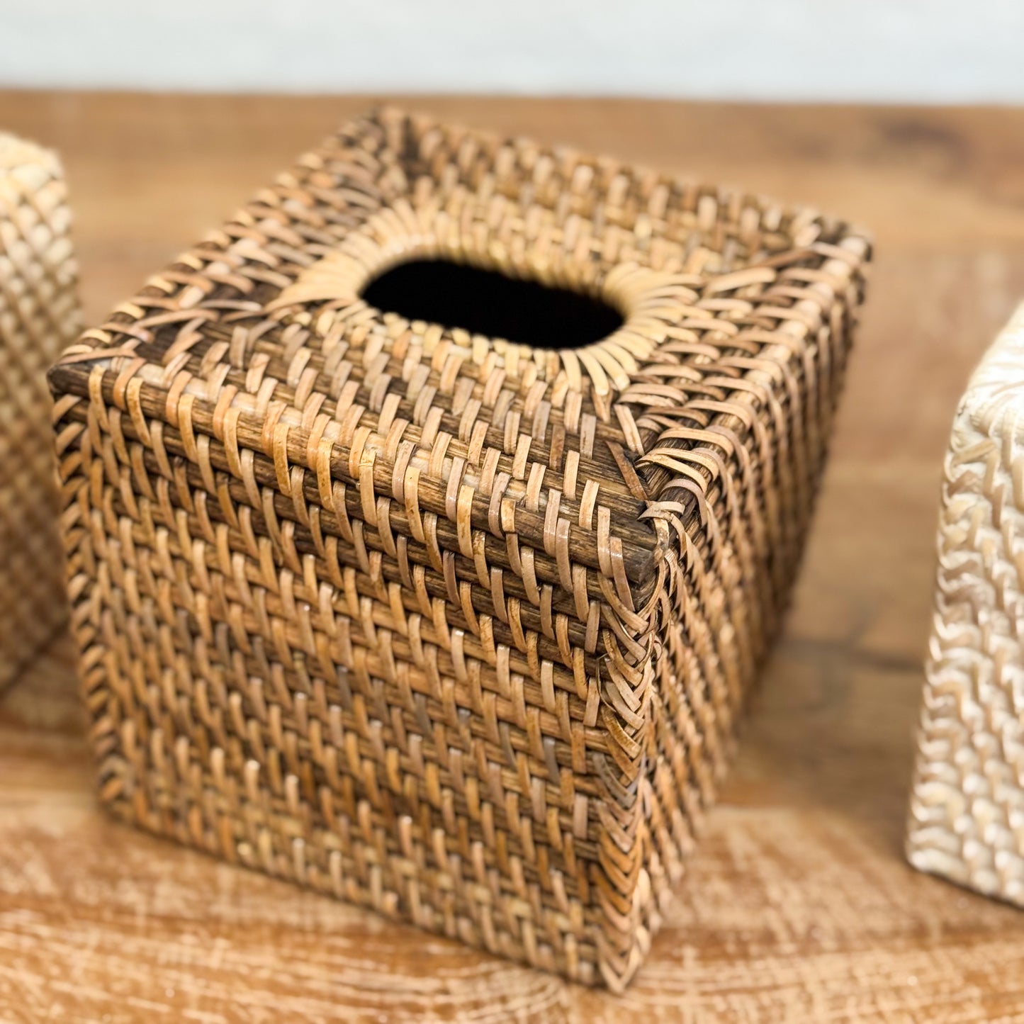Woven tissue box cover on a wooden surface