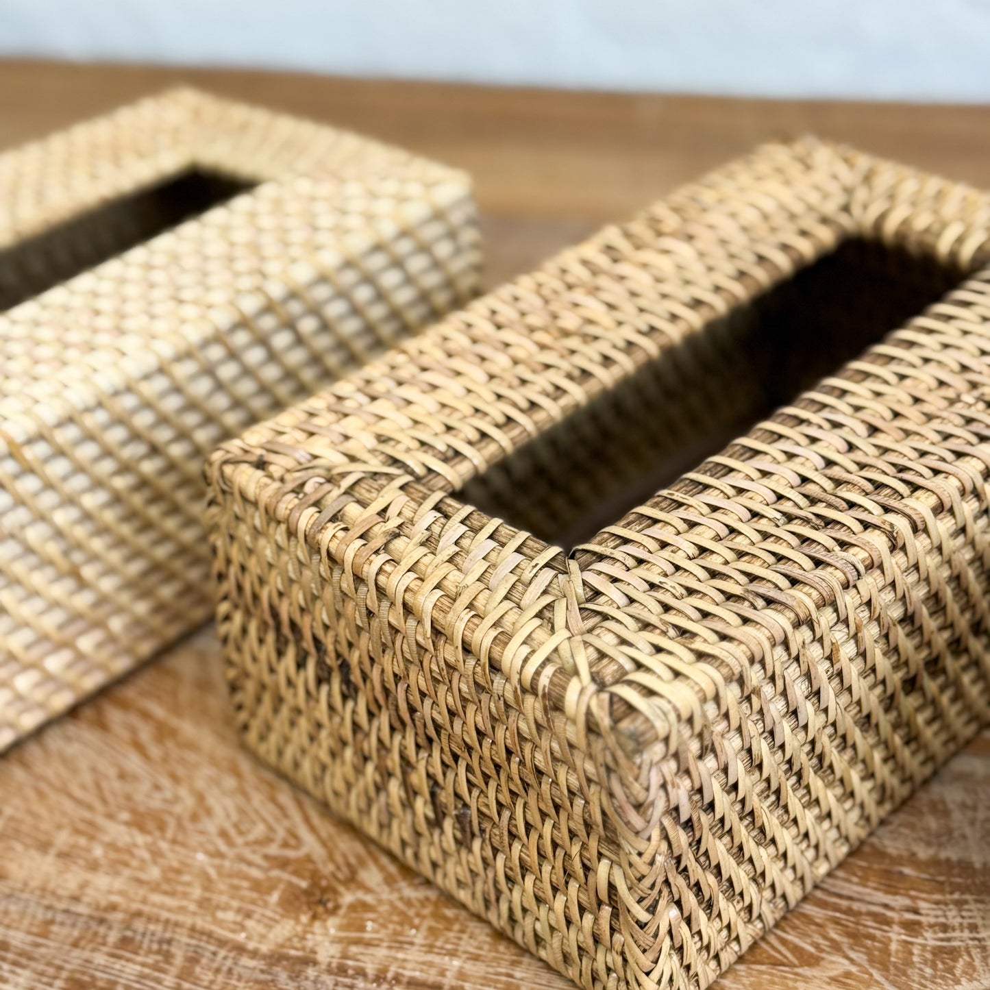 Woven tissue box cover on a wooden surface