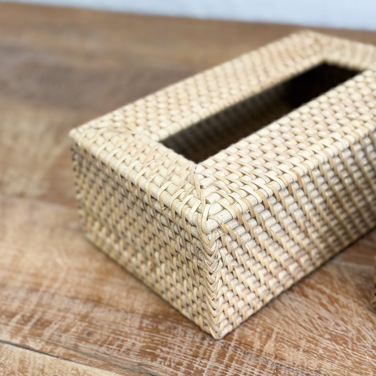 Woven tissue box on a wooden surface