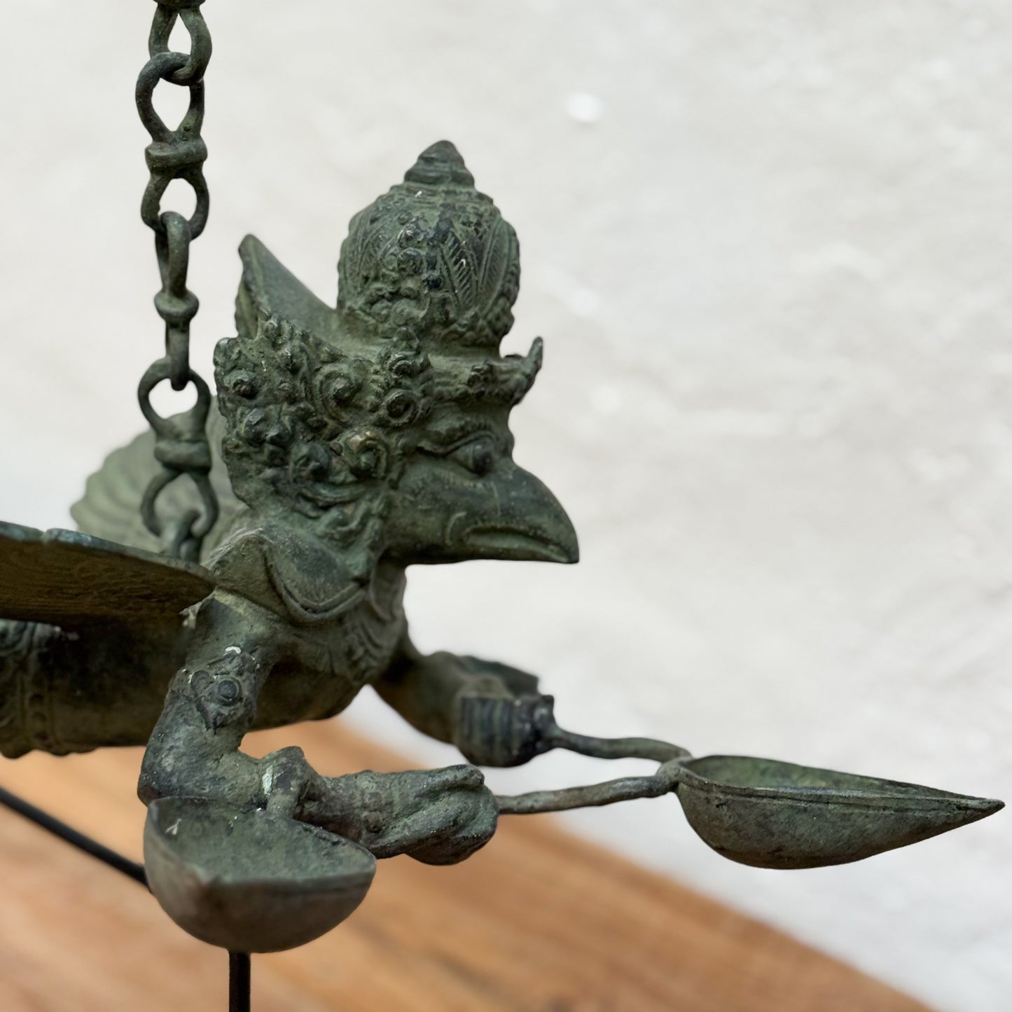 Bronze statue of a deity with multiple heads and arms on a white background