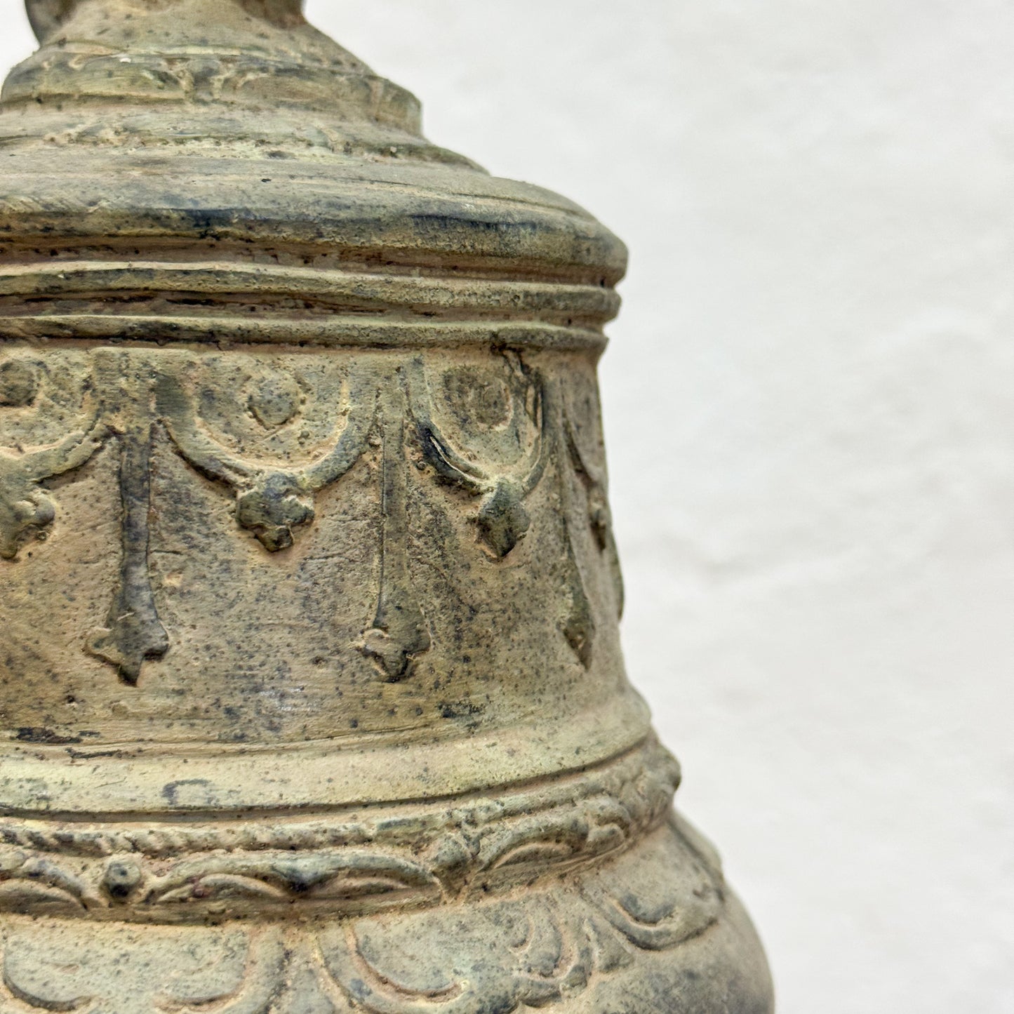 Decorative stone vase with intricate carvings on a white background