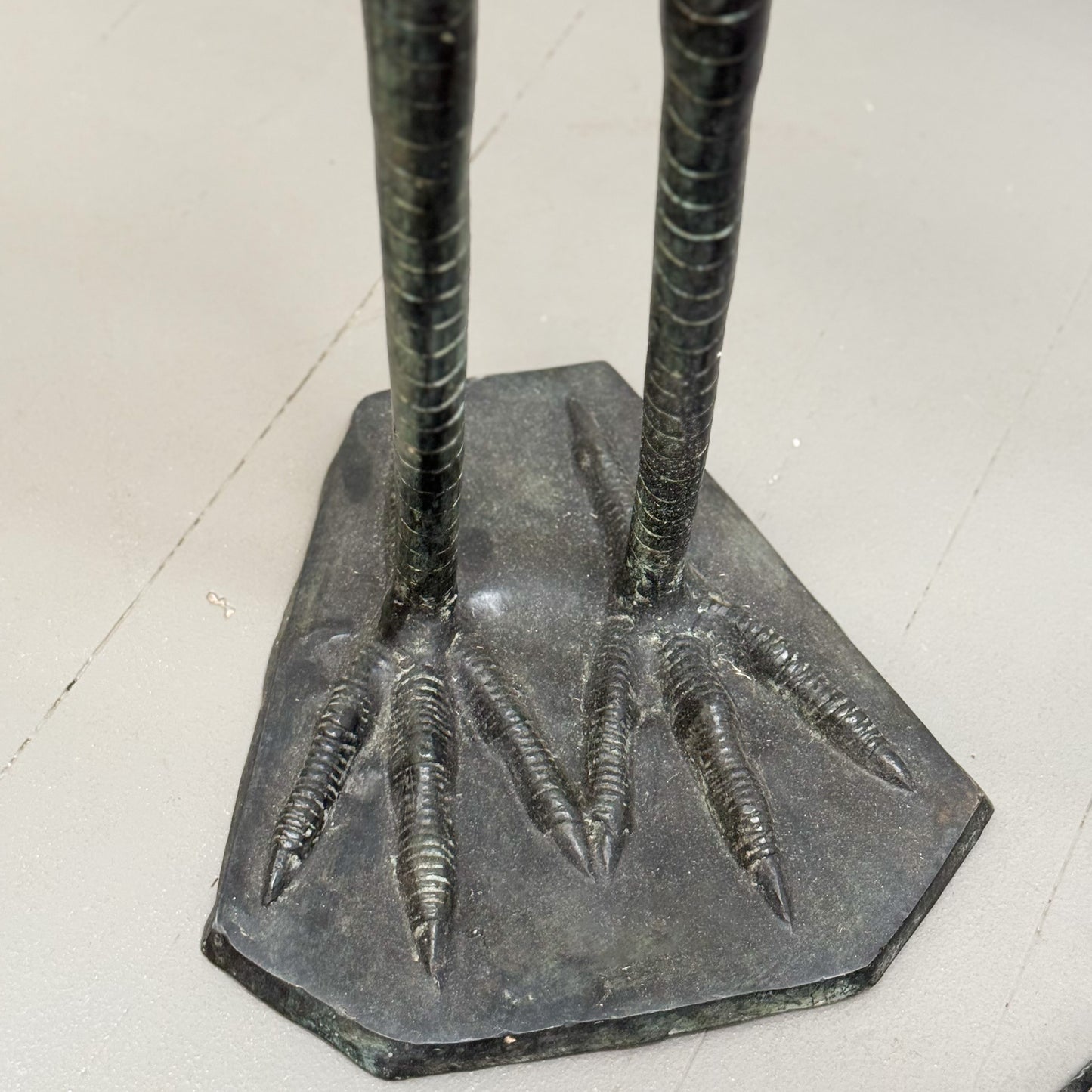 Bronze statue of a bird's feet on a hexagonal base