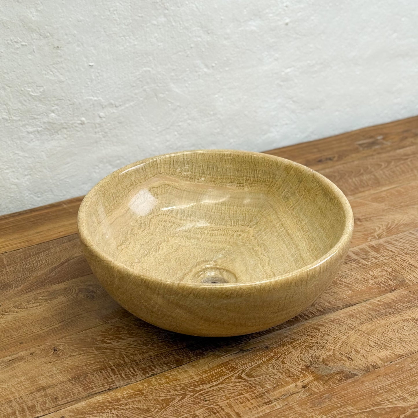 Ceramic bowl on a wooden surface with a light gray wall background