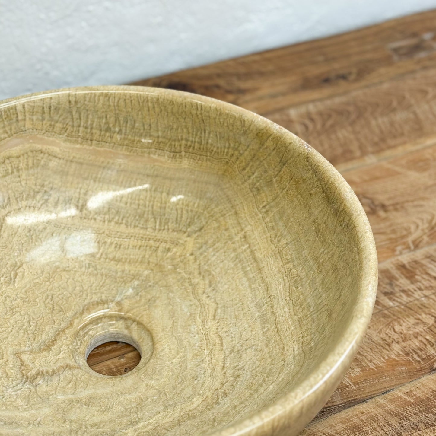 Beige ceramic sink on a wooden surface