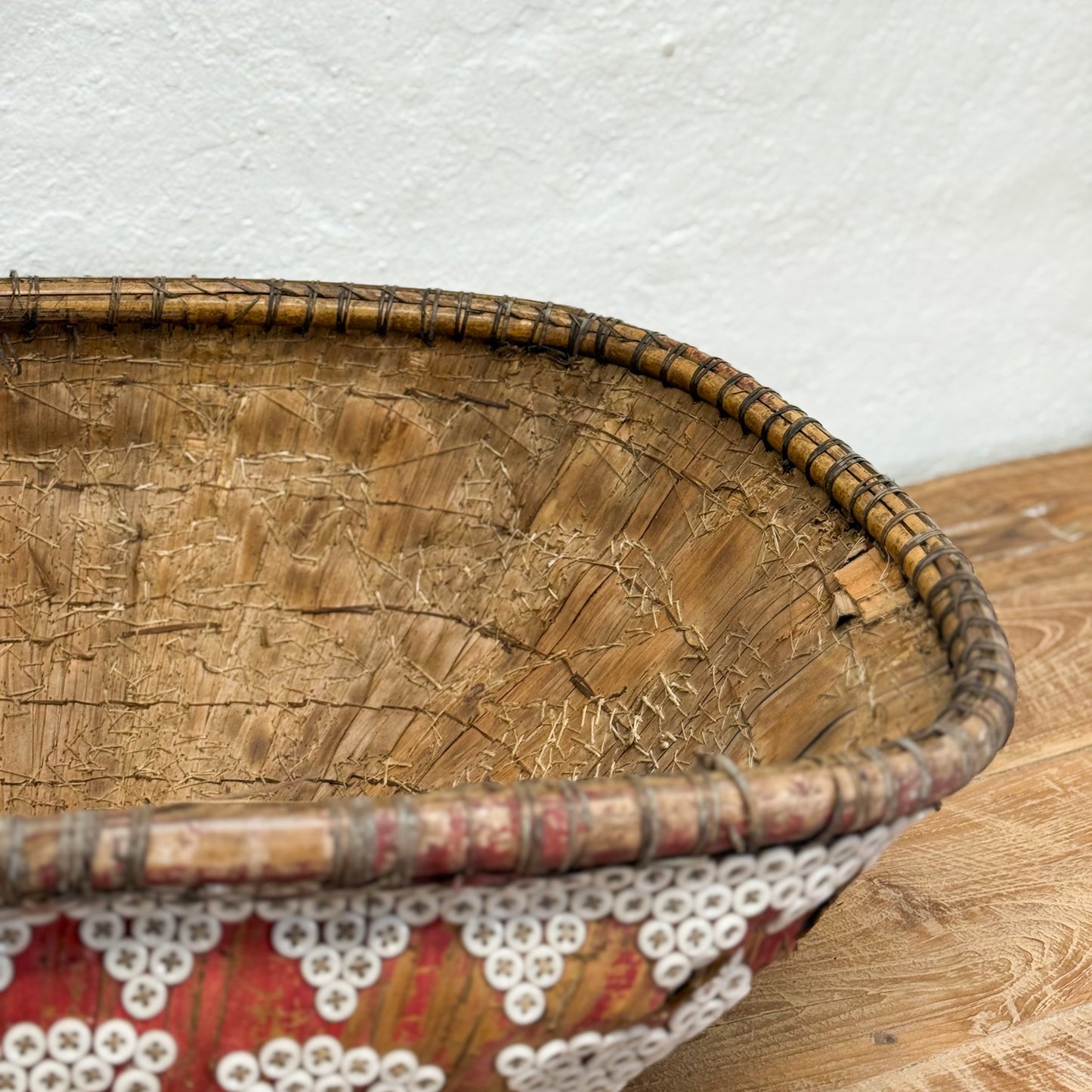 Woven basket with a lace doily on a wooden surface