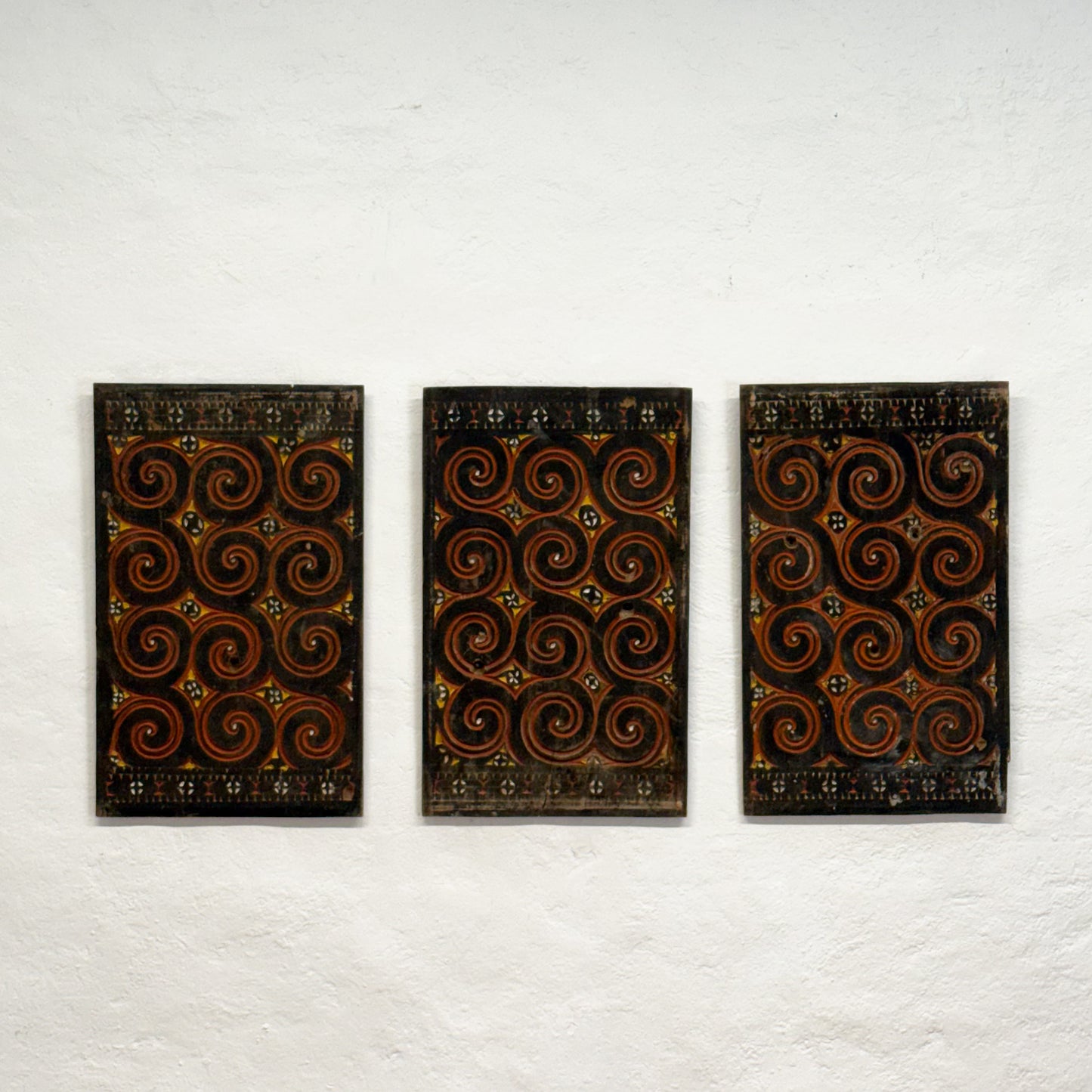 Three rectangular panels with spiral pattern on a white background