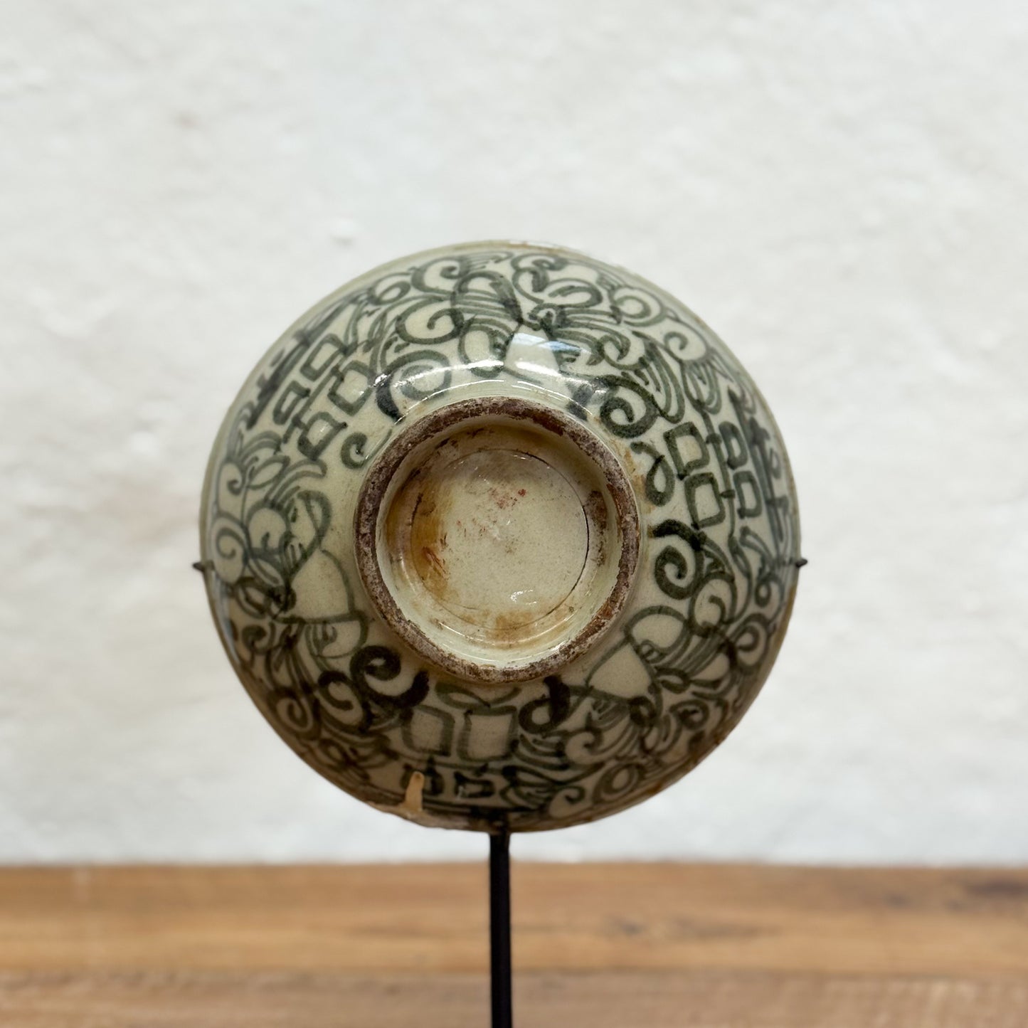 Ceramic bowl with intricate black patterns on a white background