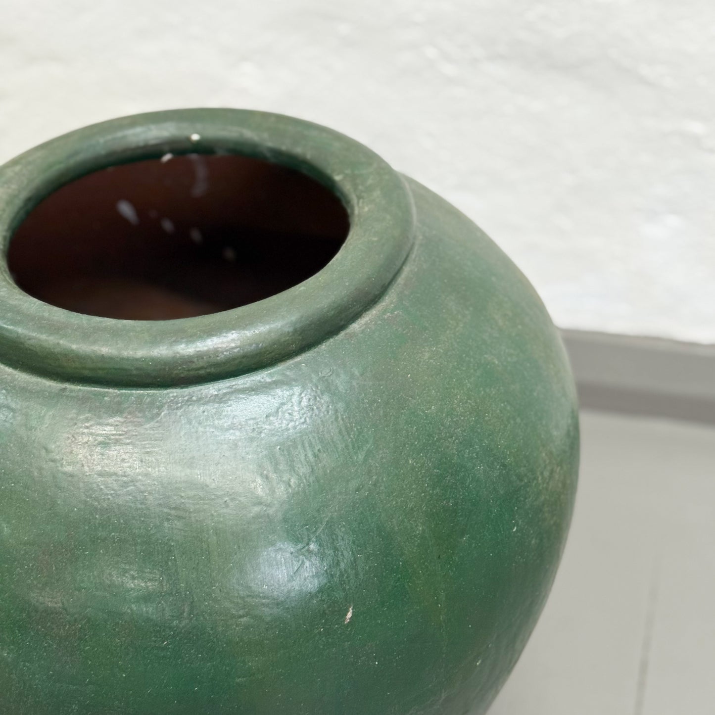 Green ceramic jar on a white background