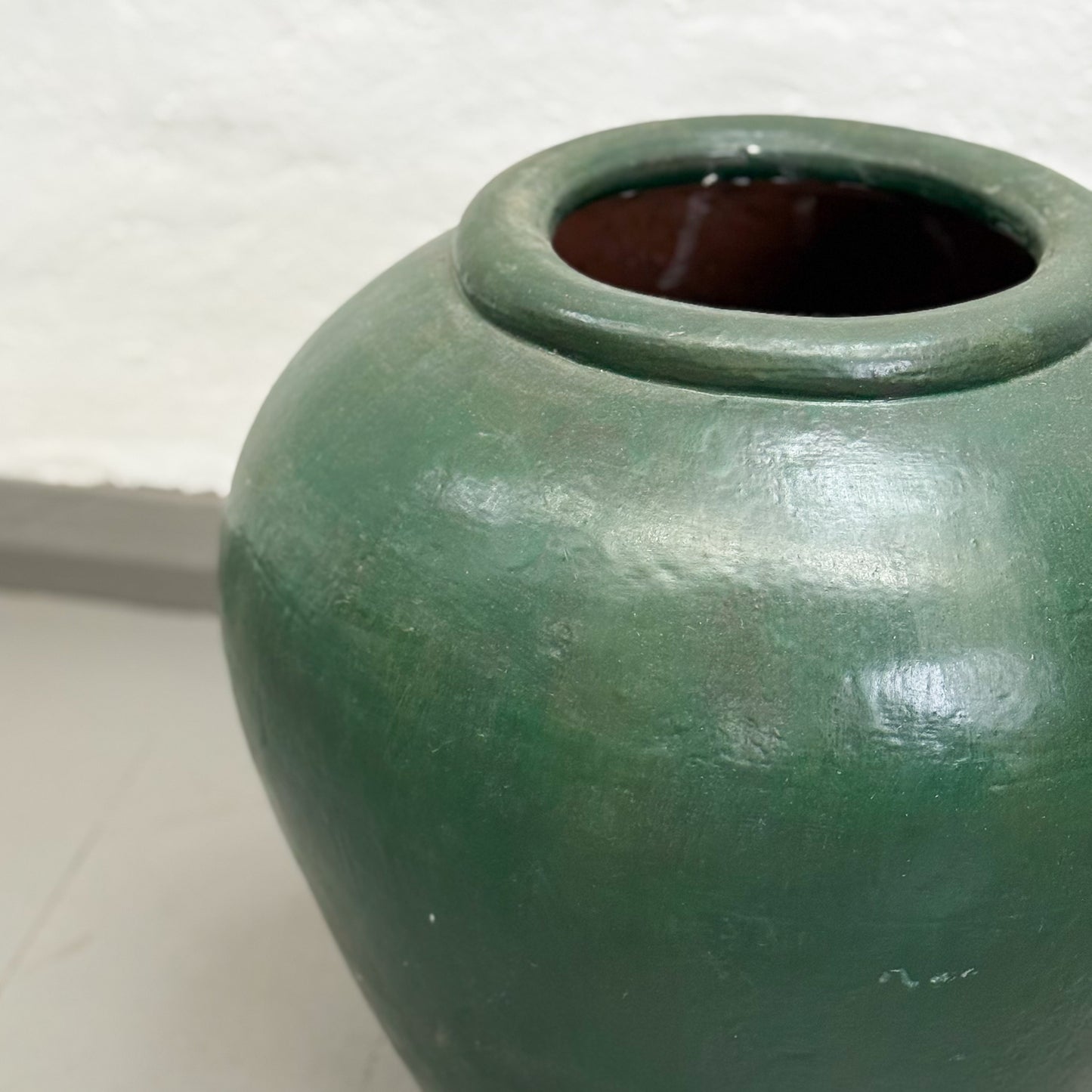 Green ceramic jar on a white background