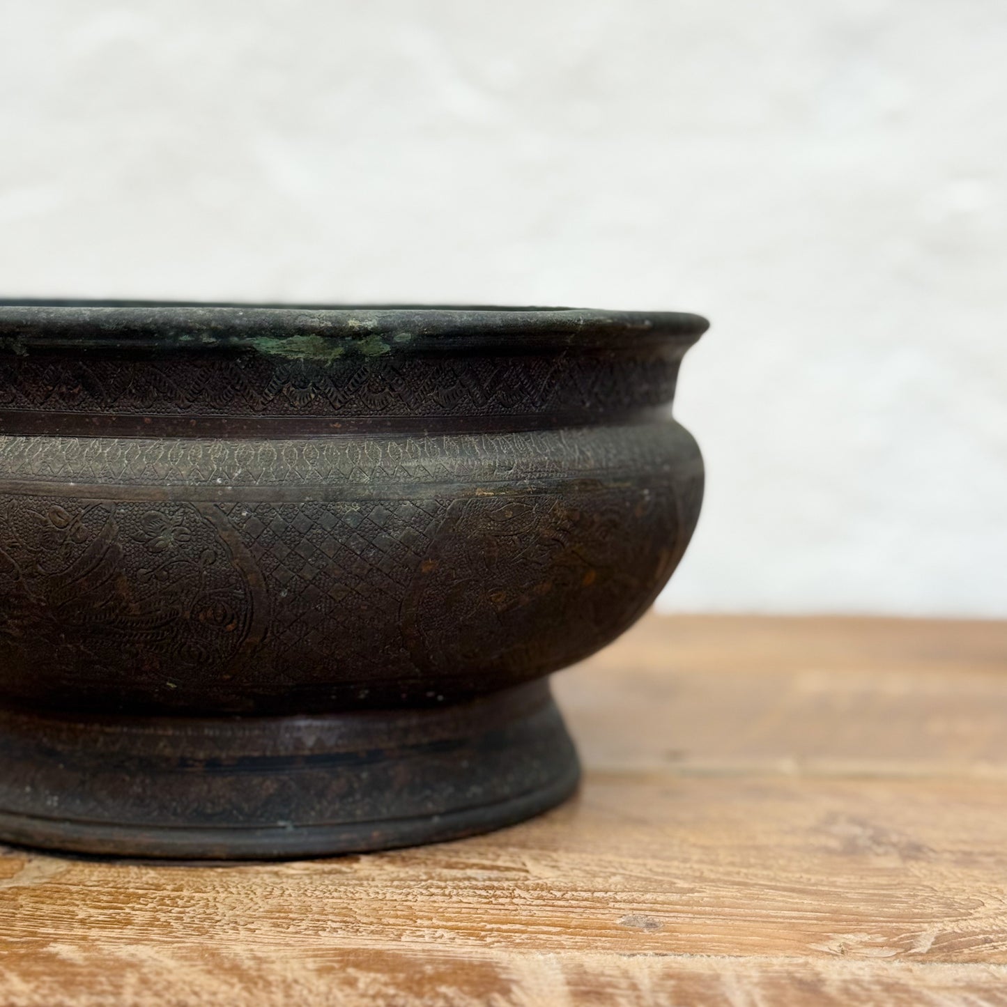 Black ceramic bowl on a wooden surface with a white background