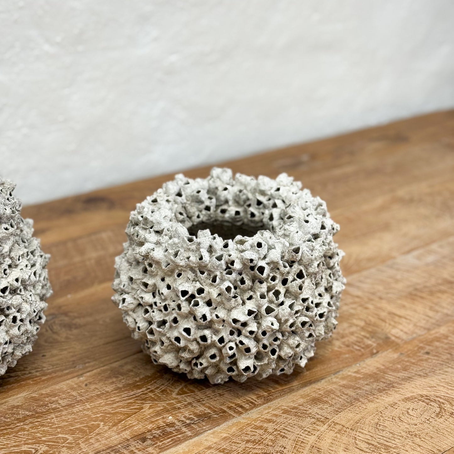 Decorative ceramic pots with textured surface on a wooden surface