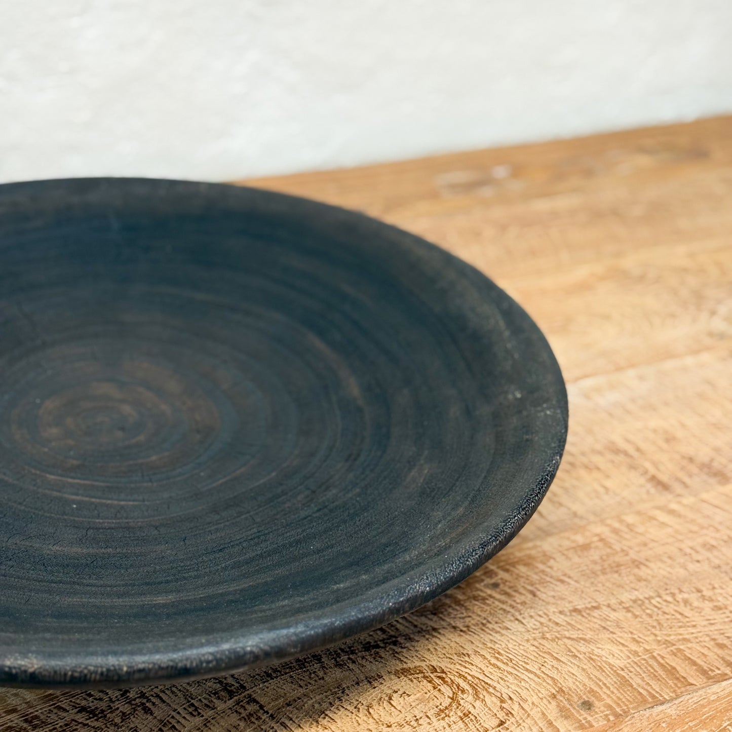 Black ceramic plate on a wooden surface