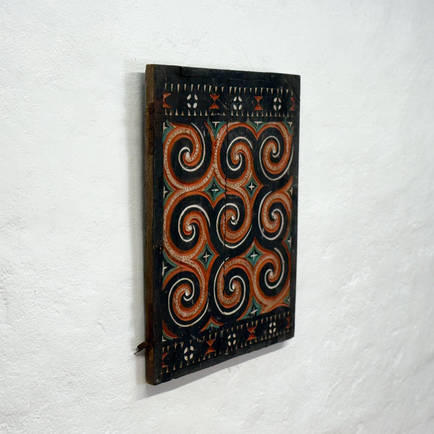 Decorative wall panel with spiral patterns on a white background