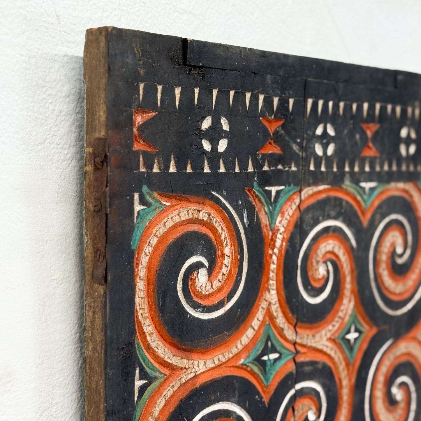 Decorative wooden panel with intricate patterns on a white background