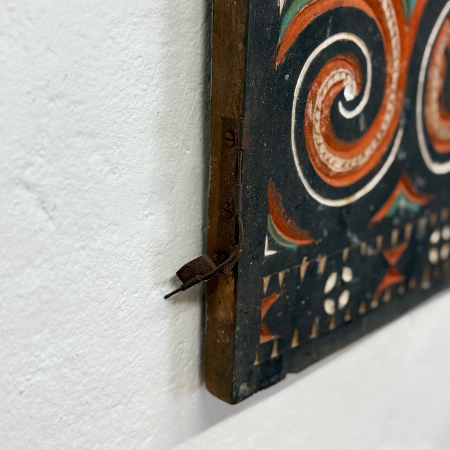 Decorative wooden panel with intricate carvings on a white background