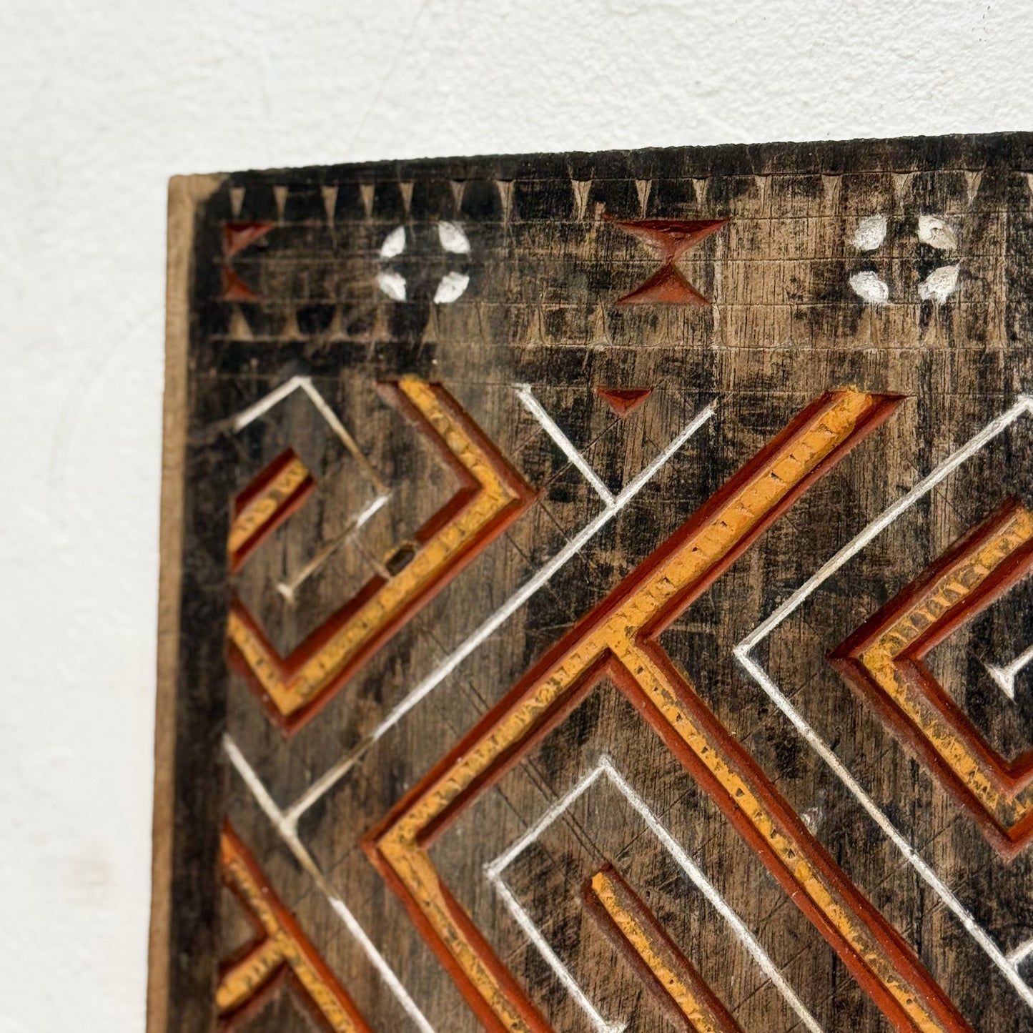 Close-up of a textured surface with geometric patterns in brown, white, and black.