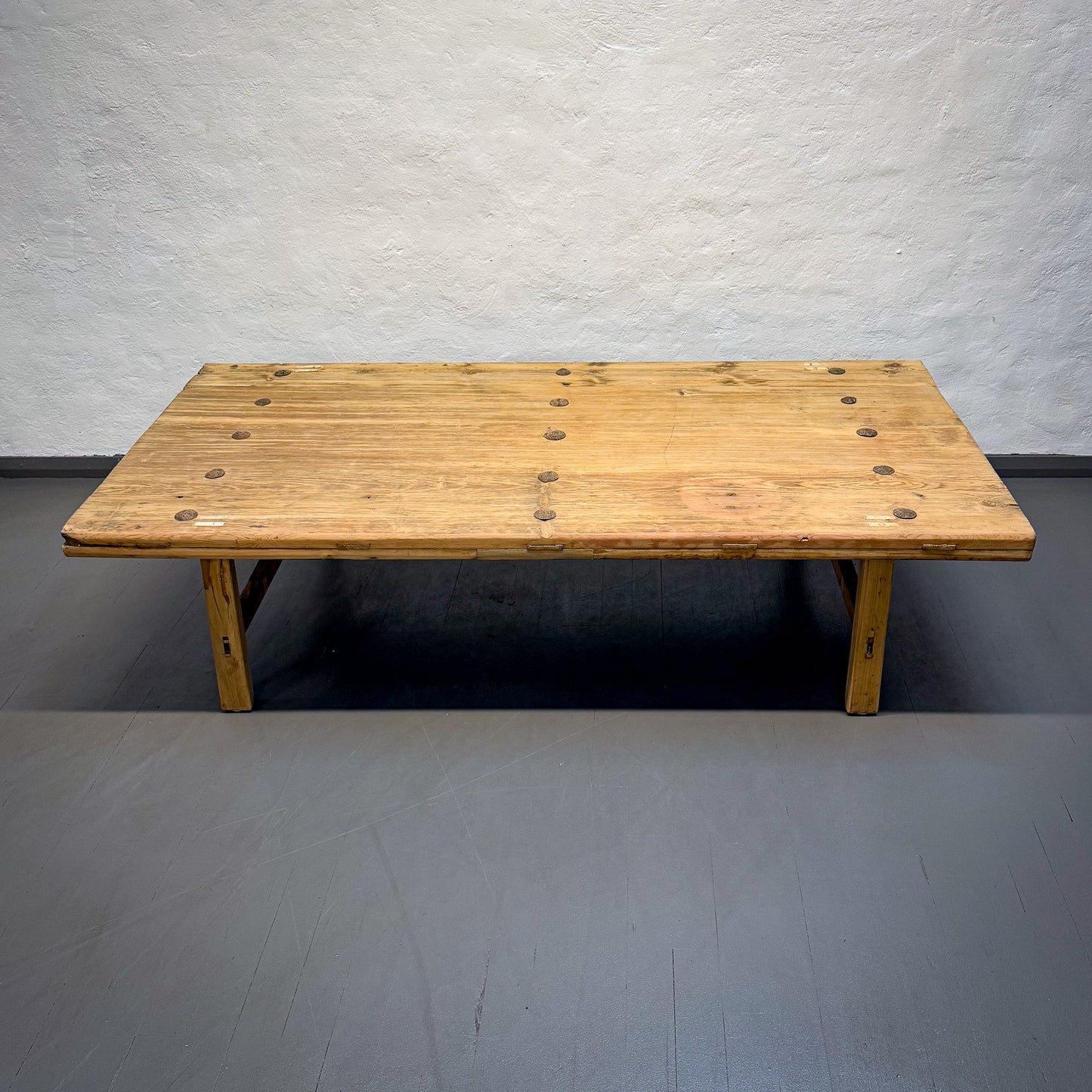 Wooden table against a plain wall
